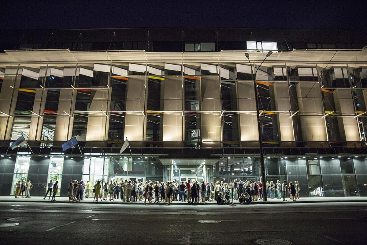 Tallinn University Astra building at nigt with crowds in front of it